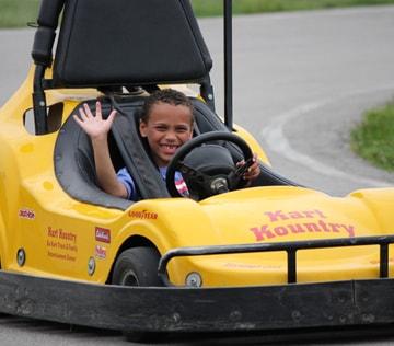 A young driver smiling in a go-kart on Thunder Road